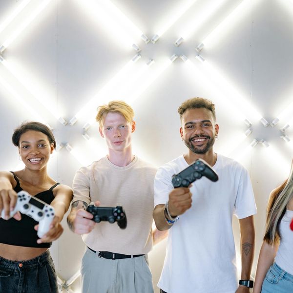 Diverse group of people smiling in a bright yoga studio.